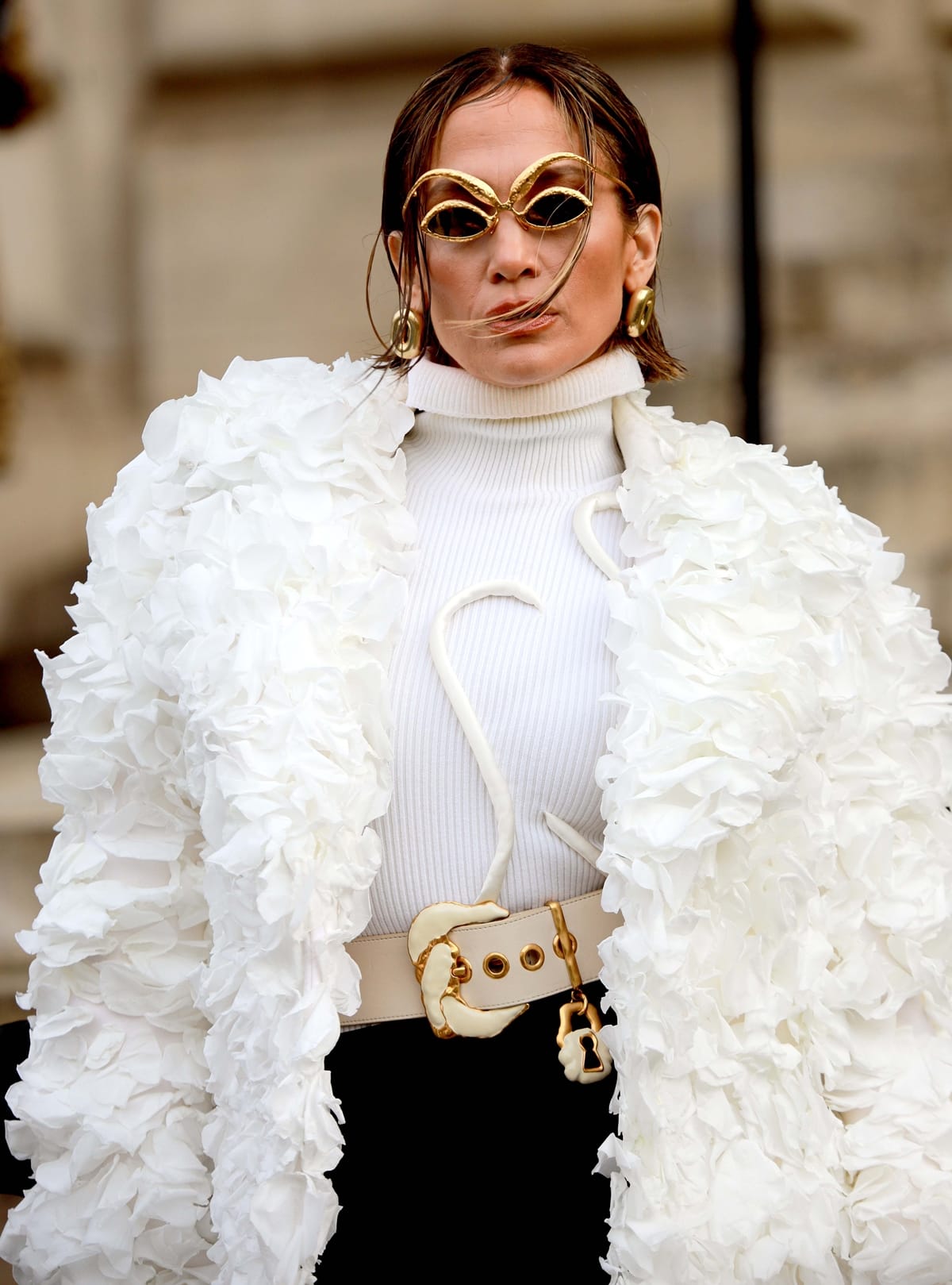 Accentuating her haute couture look, Jennifer Lopez sports quirky metal gold sunglasses with almond-shaped lenses and thick frames