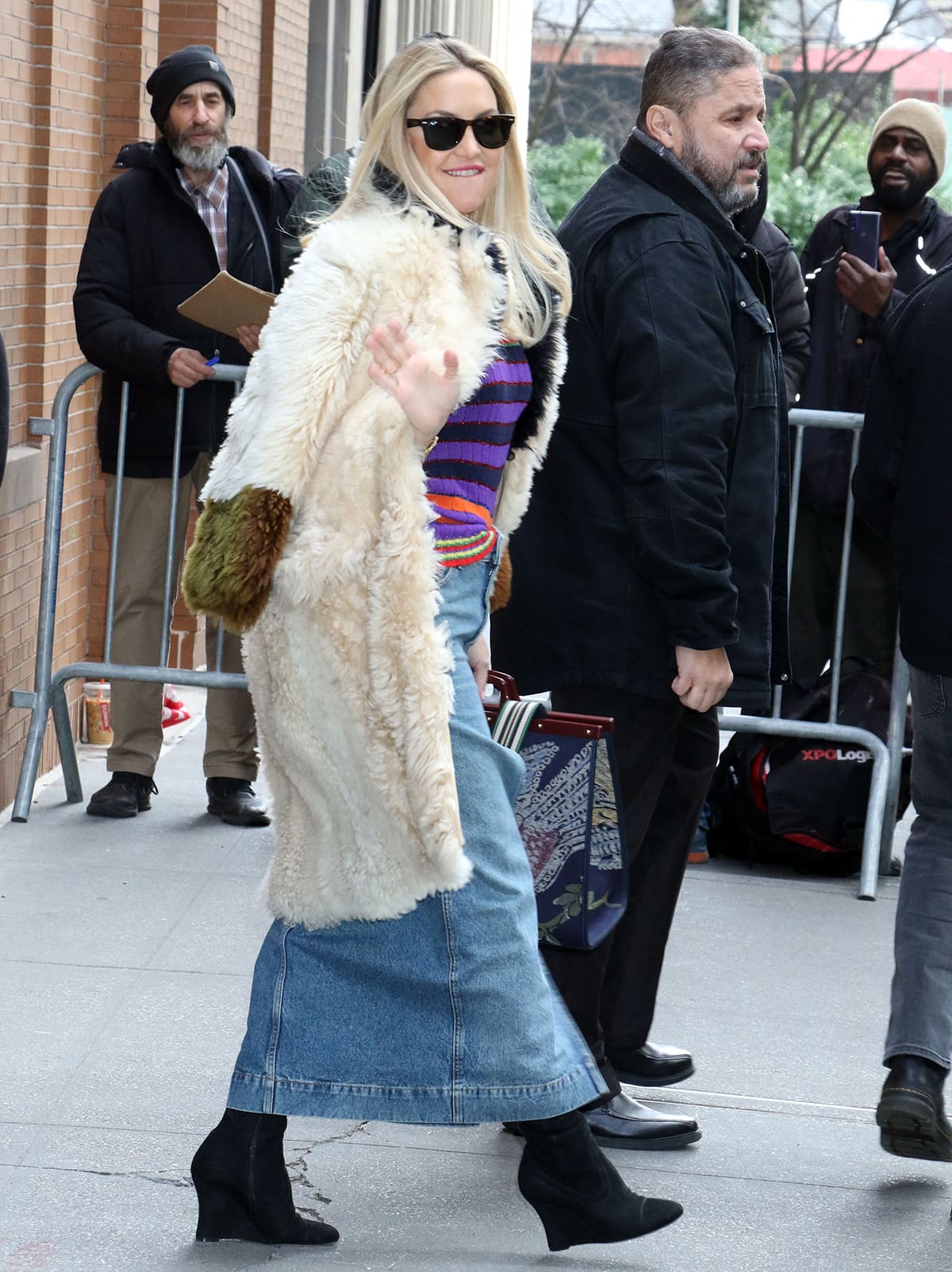 Kate Hudson teams her Gucci striped sweater and denim midi skirt with black over-the-knee boots and thick Marni fur coat