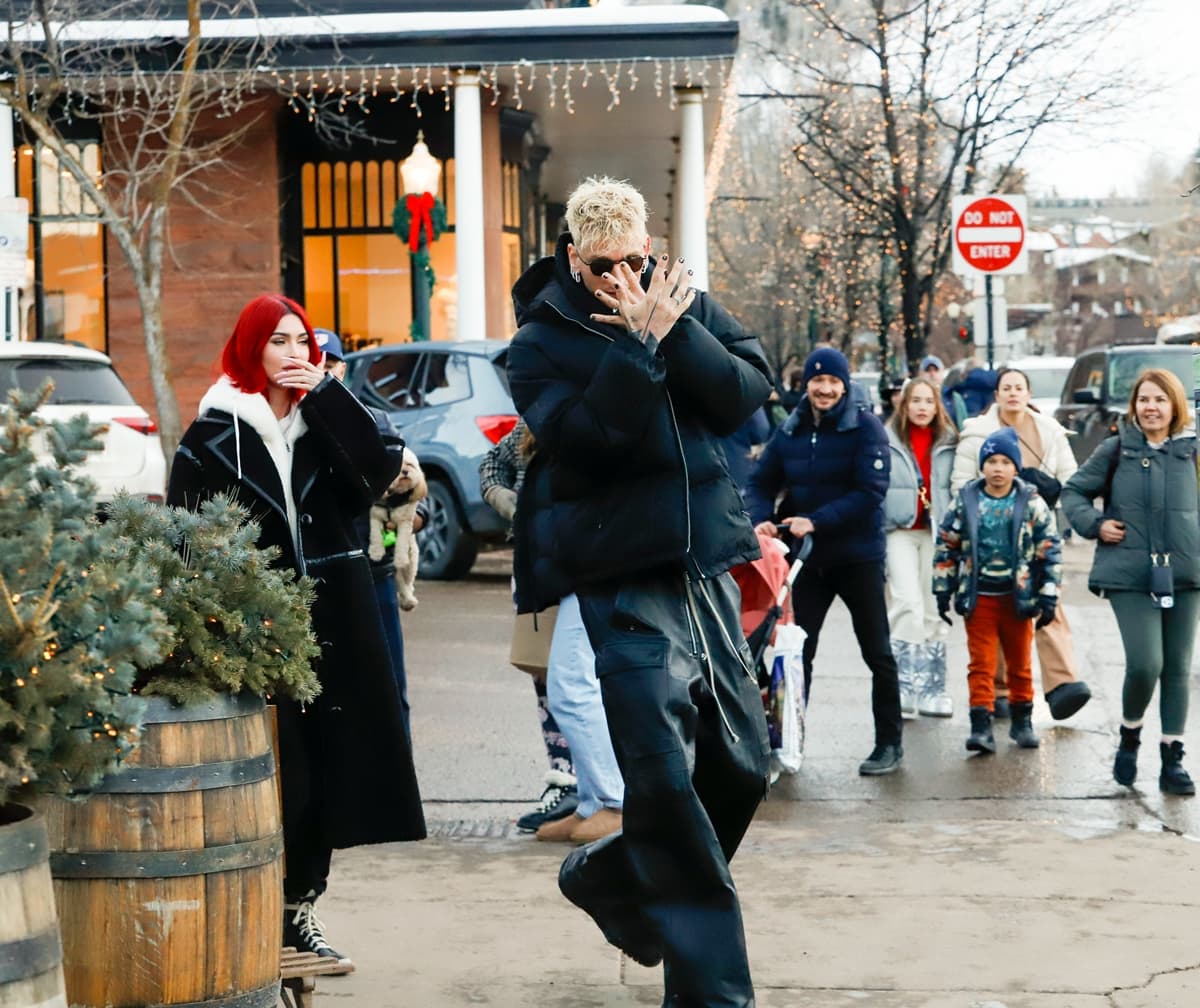 Urban Winter Cool: MGK complements Megan's elegance with a monochrome Gucci ensemble, adding a rugged charm to their snowy stroll