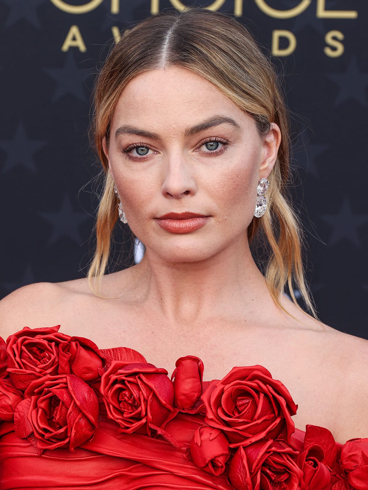 Margot Robbie's 2024 Critics Choice Awards all-red look was completed with nearly 100-carat diamond jewelry by Lorraine Schwarz, estimated to be worth $10 million
