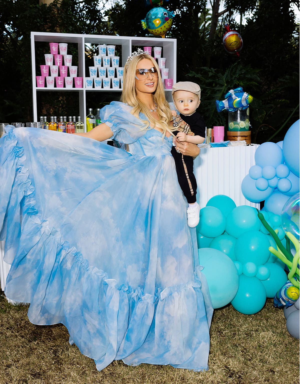 Paris Hilton channels her inner princess in a powder blue gown with puffy short sleeves, frills, and a sweetheart neckline