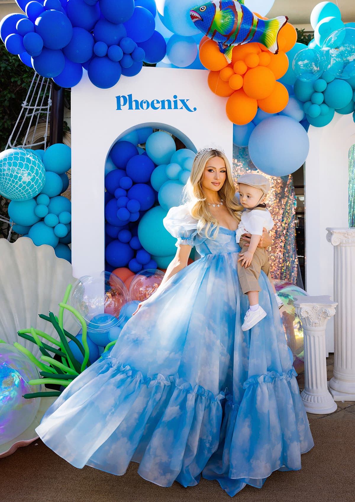 Paris Hilton carrying her son Phoenix in front of a balloon-filled backdrop designed by Balloon and Paper