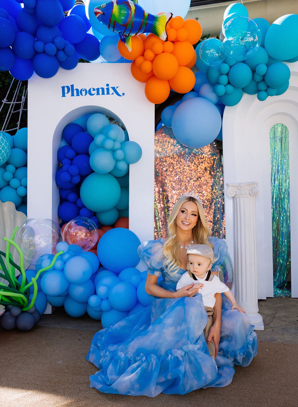 Paris Hilton's son Phoenix looks adorable in his white Fendi shirt, tan pants, and newsboy cap