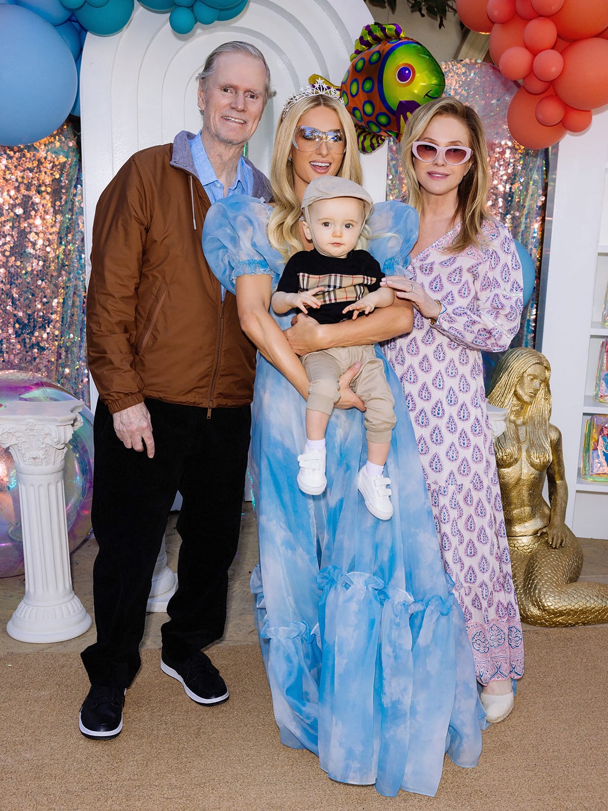 Paris Hilton and her son Phoenix take a photo with her parents Rick and Kathy Hilton