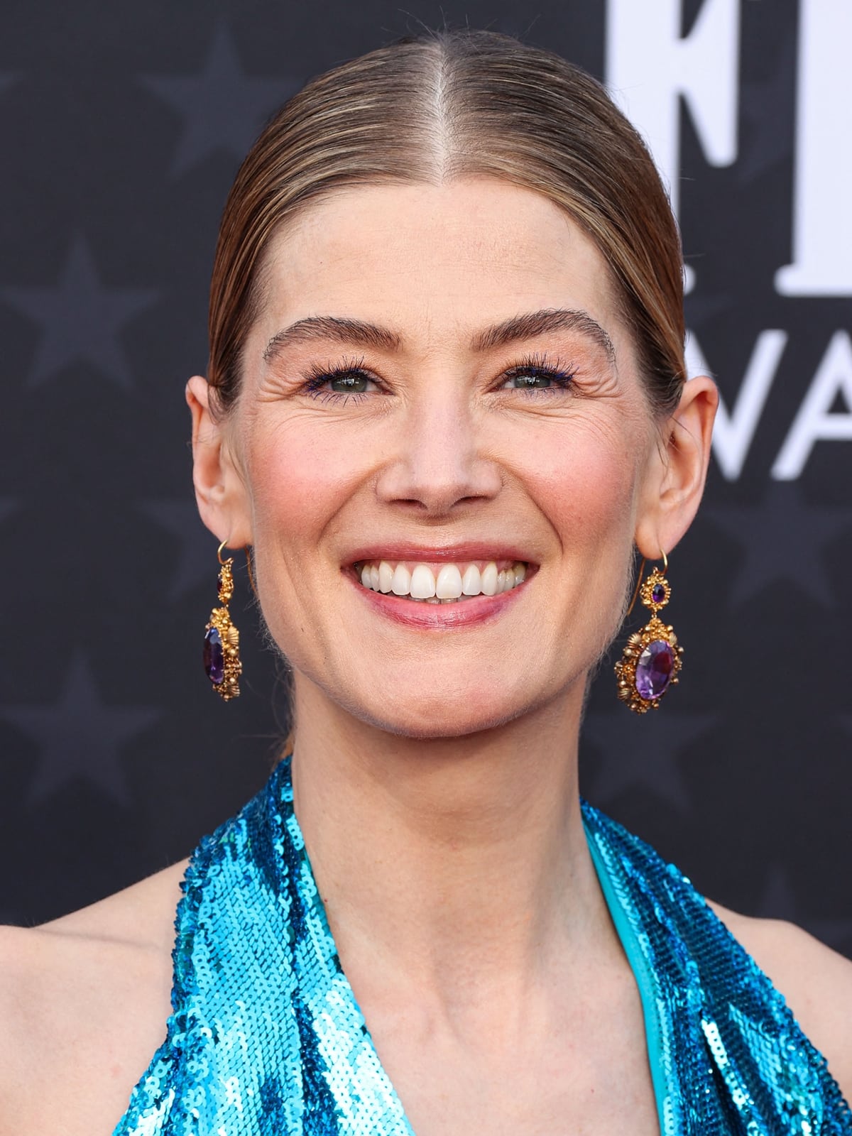 Accented with Fred Leighton's Georgian yellow gold and amethyst jewelry, her look is completed with a classic makeup palette by Melanie Inglessis and a chic blonde updo, encapsulating timeless Hollywood glamour