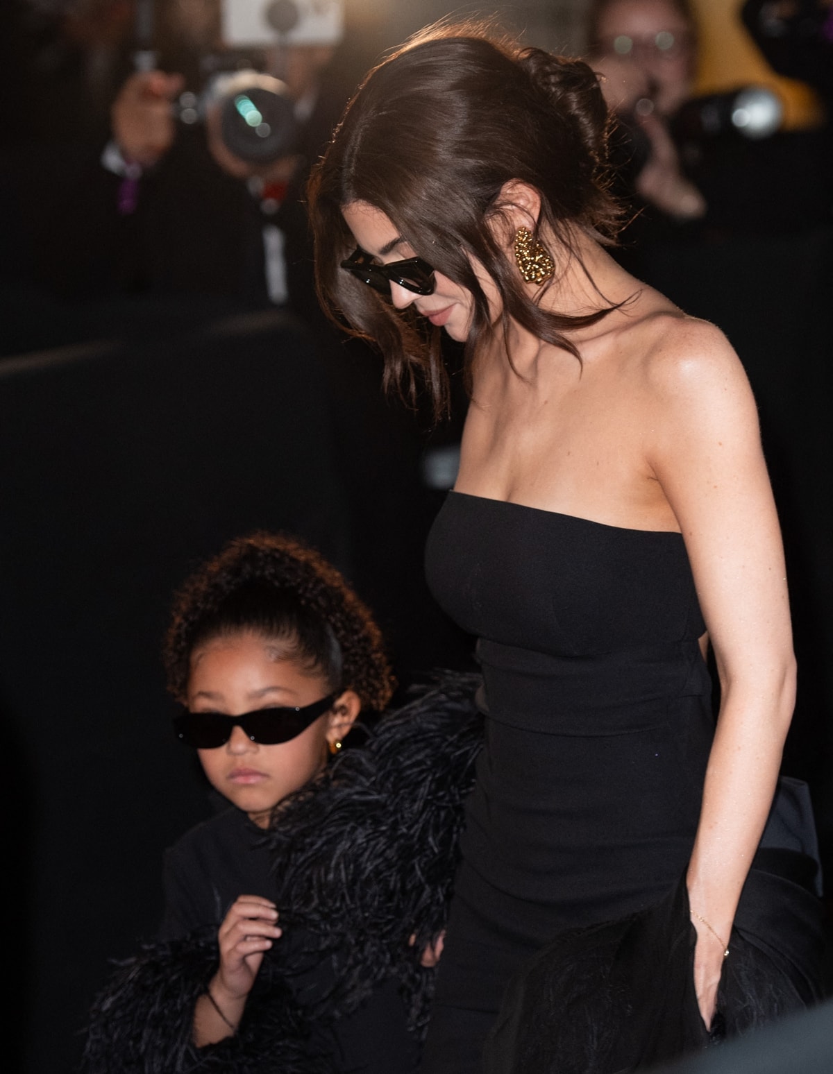 Stormi Webster, stepping into the spotlight, mirrors her mother's fashionista flair at just five years old, with a mini-version of Kylie's elegant black dress