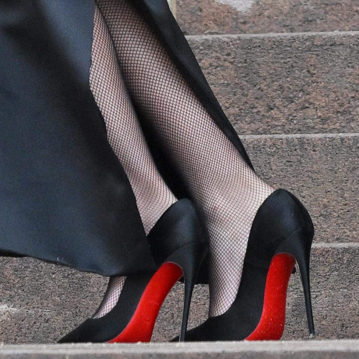 A zoomed-in shot of Zendaya's feet, accentuating the iconic red soles of her Christian Louboutin stiletto pumps