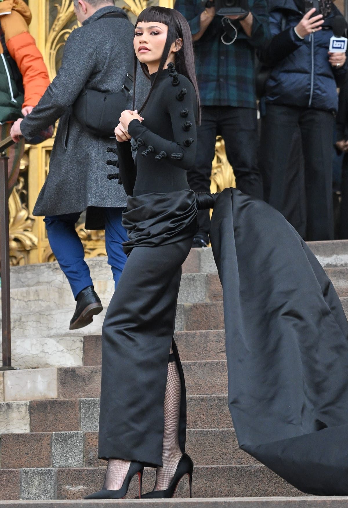 Zendaya steps onto the scene at the Schiaparelli Haute Couture Spring/Summer 2024 show, exuding confidence and style in her sleek black gown during Paris Fashion Week