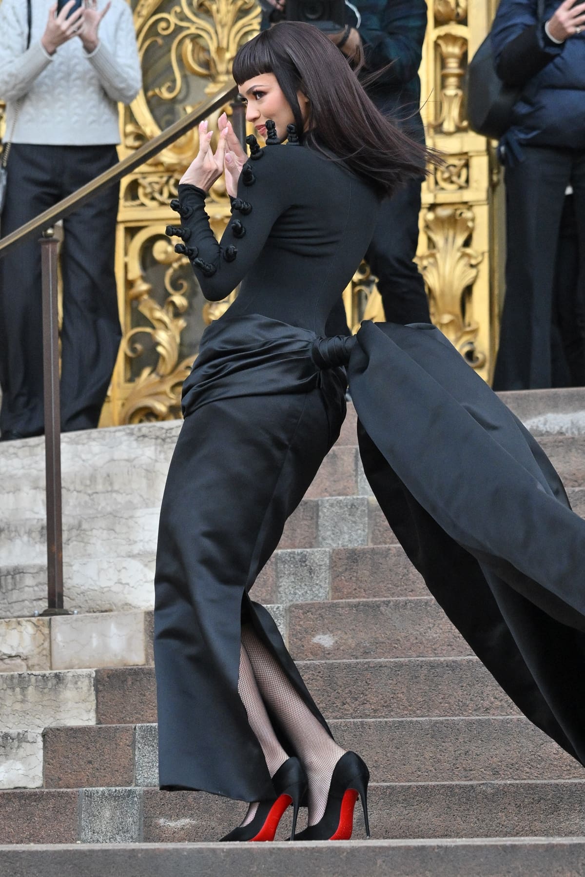 Zendaya ascended the grand steps of Place Vendôme, her ruched black satin skirt flowing majestically with each step, embodying the epitome of modern elegance