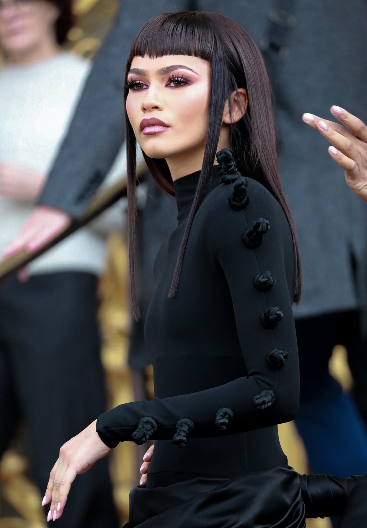 A detailed view of Zendaya's daring new hairstyle, featuring choppy micro bangs and sleek, straight locks, marking a significant departure from her usual styles