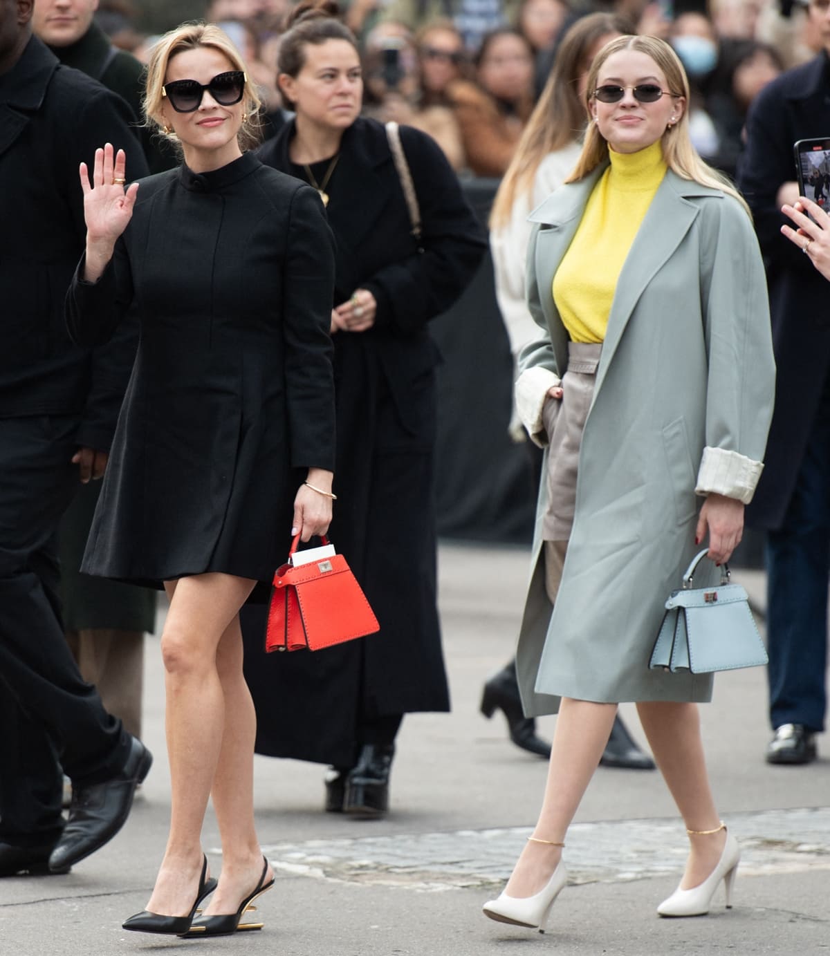 Ava Phillippe brightens the scene with her vibrant sunflower yellow turtleneck and taupe leather miniskirt, stylishly accented with white pumps featuring gold ankle straps
