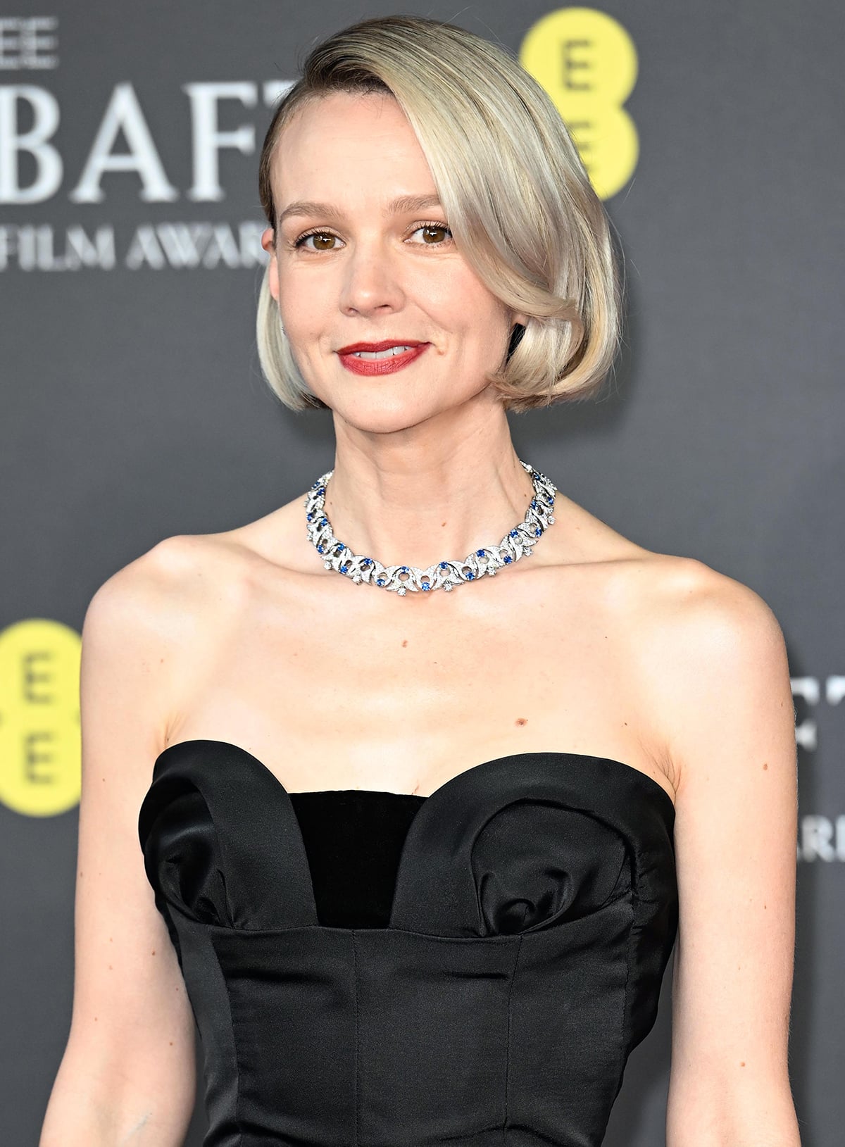 Carey Mulligan styles her black dress with an opulent Bulgari diamond necklace and diamond earrings