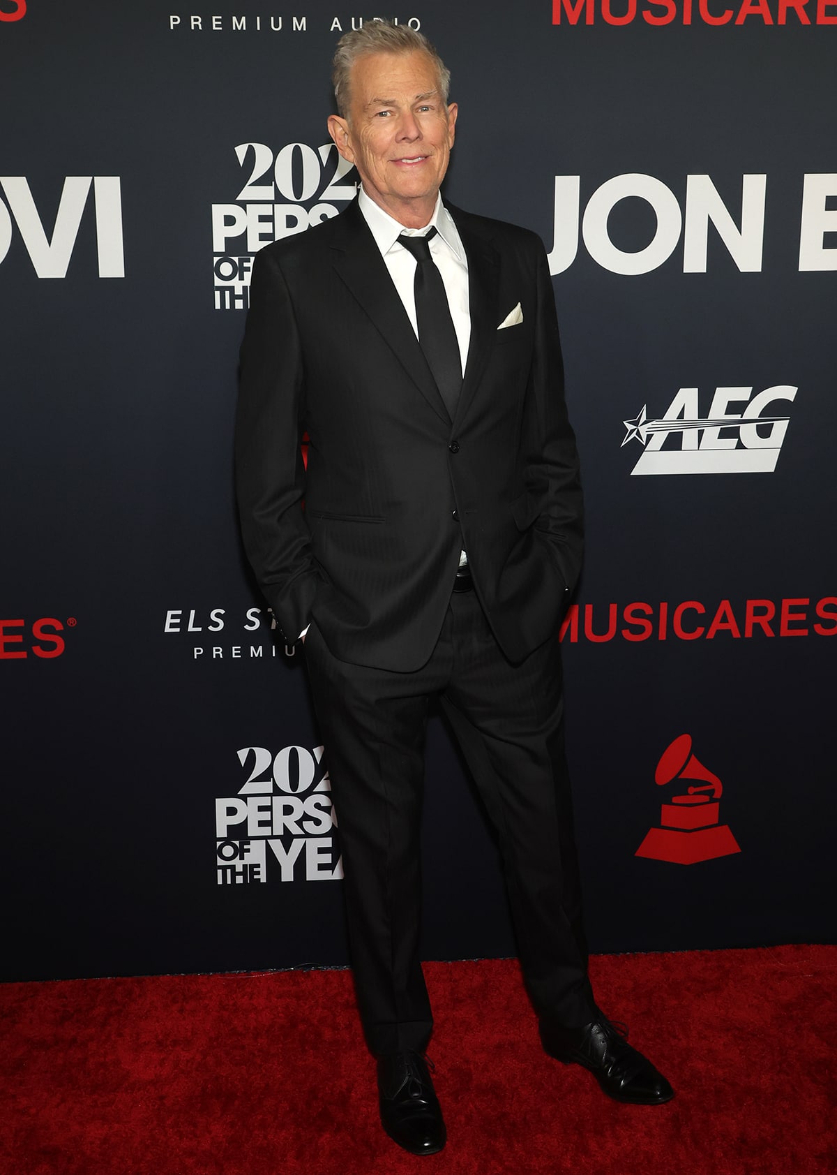 David Foster arrives at the 2024 MusiCares Gala honoring Jon Bon Jovi in a classic single-breasted suit and oxford shoes