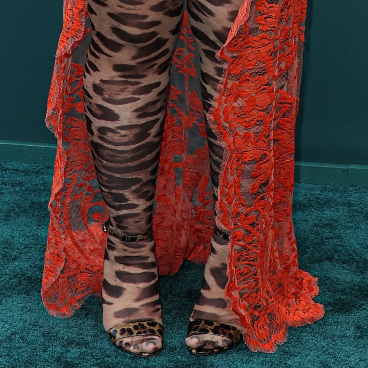 Pairing leopard-print tights with strappy open-toe sandals, Ice Spice adds a touch of 2010s retro chic