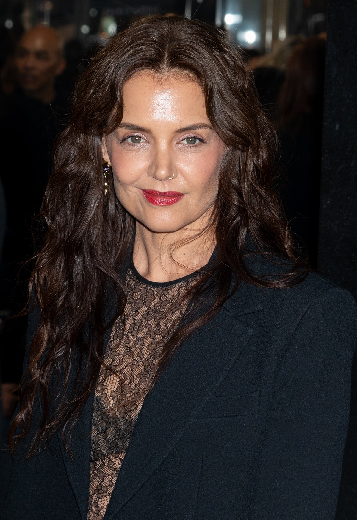 Katie Holmes keeps her look sensual with beachy waves and bold red lips