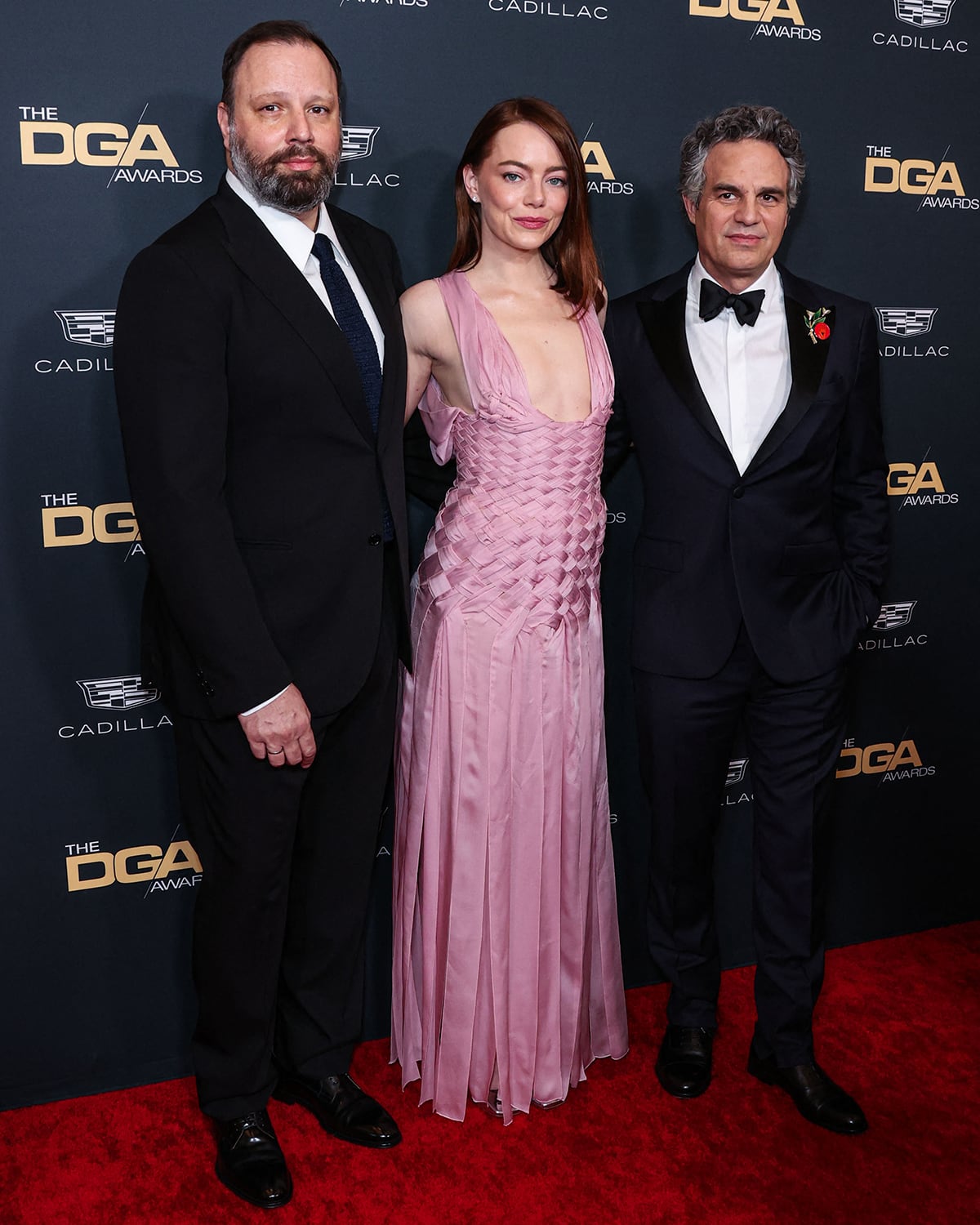 Poor Things director Yorgos Lanthimos, actress Emma Stone, and her co-star Mark Ruffalo pose together at the 76th Annual Directors Guild of America Awards held at the Beverly Hilton Hotel on February 10, 2024