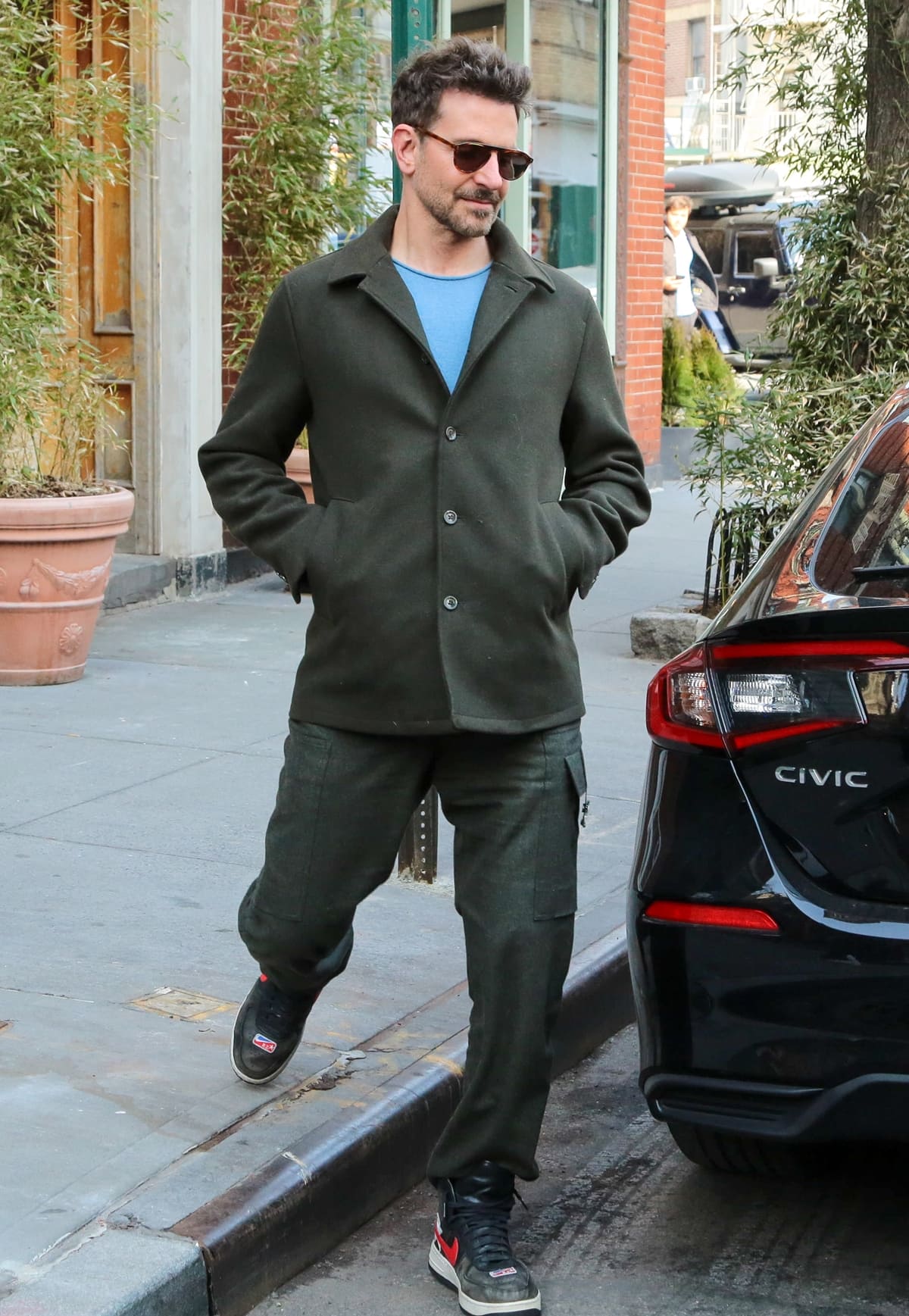 Bradley Cooper perfects casual elegance, pairing coordinated pants with the distinctive Nike Air Force 1 High sneakers by Riccardo Tisci, from the "Victorious Minotaurs" Pack