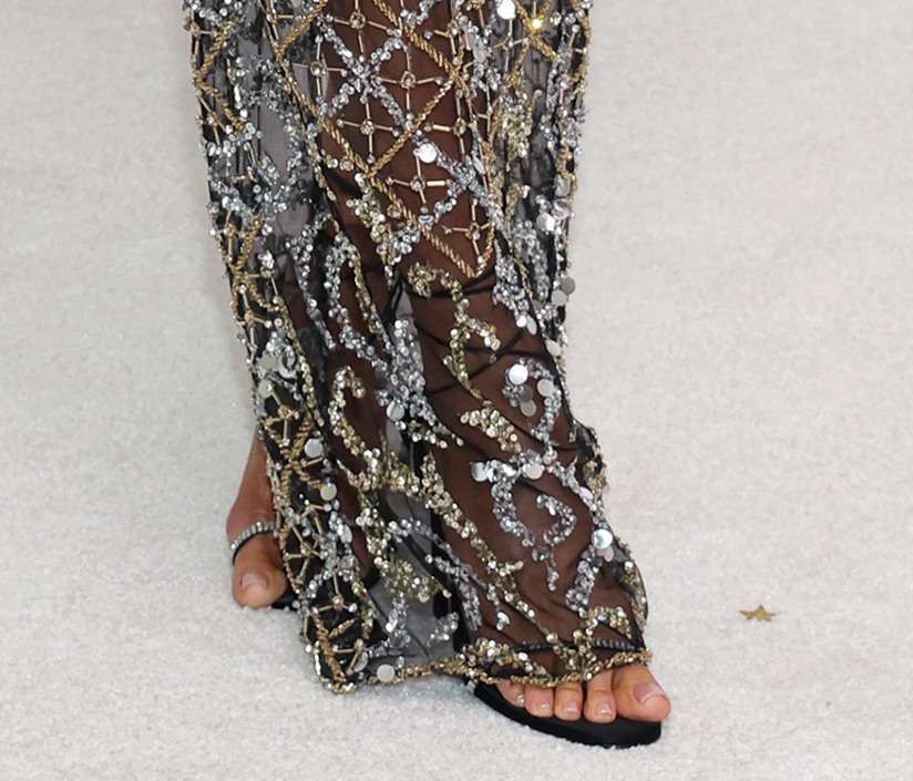 Heidi Klum pairs her black and silver gown with coordinating black satin crystal-embellished sandals by Alevi