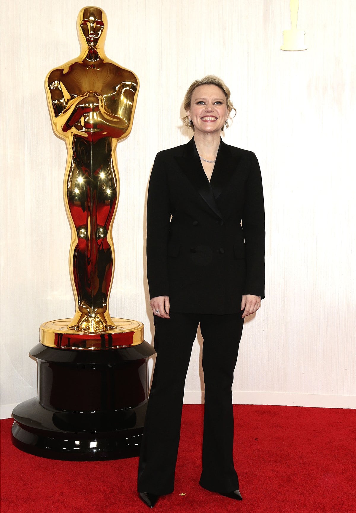 Kate McKinnon opts to power dress at the 2024 Oscars in a black double-breasted suit on March 10, 2024