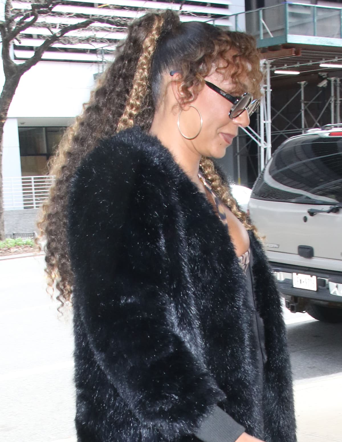 Mel B layers her daring leopard-print jumpsuit underneath a black furry coat outside the Drew Barrymore Show studios