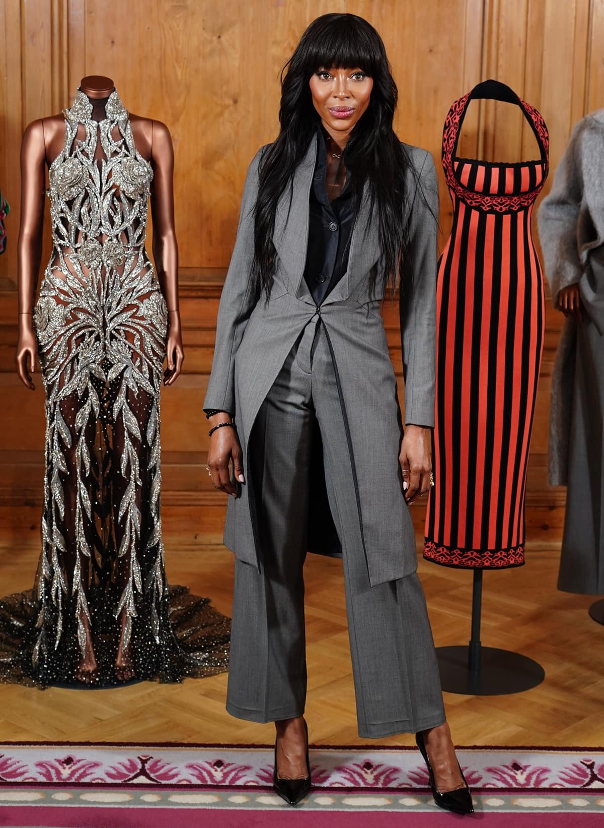 Naomi Campbell, exuding timeless elegance in an Alexander McQueen vintage suit, at the opening of her personal style retrospective, NAOMI: In Fashion, at The Dorchester, London