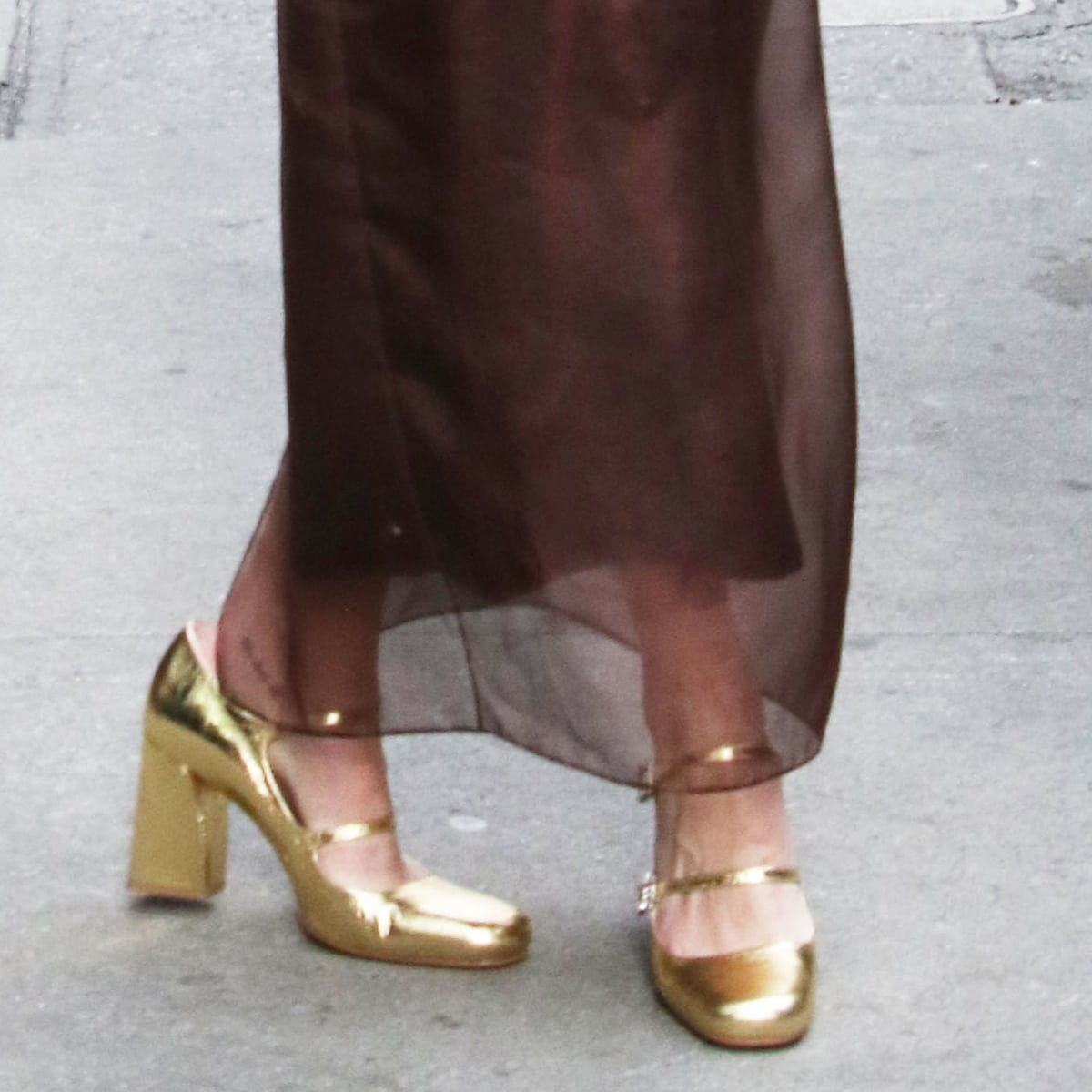 Rebecca Hall's ensemble is impeccably finished with Roger Vivier's gold metallic Mary Janes, adding a splash of luxury and a sparkle of glamour to her every step