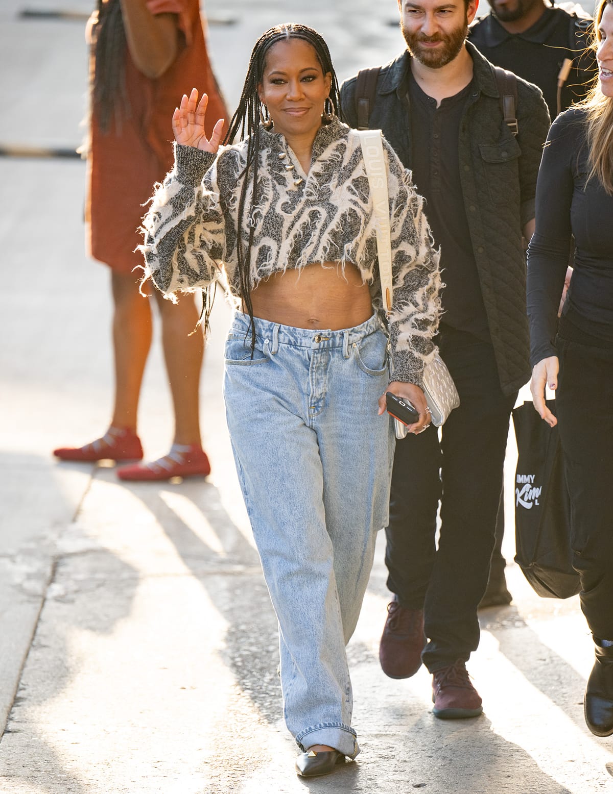Regina King bares her midriff in a fuzzy crop top and low-waist jeans on her way to promote Shirley on Jimmy Kimmel Live! on March 22, 2024