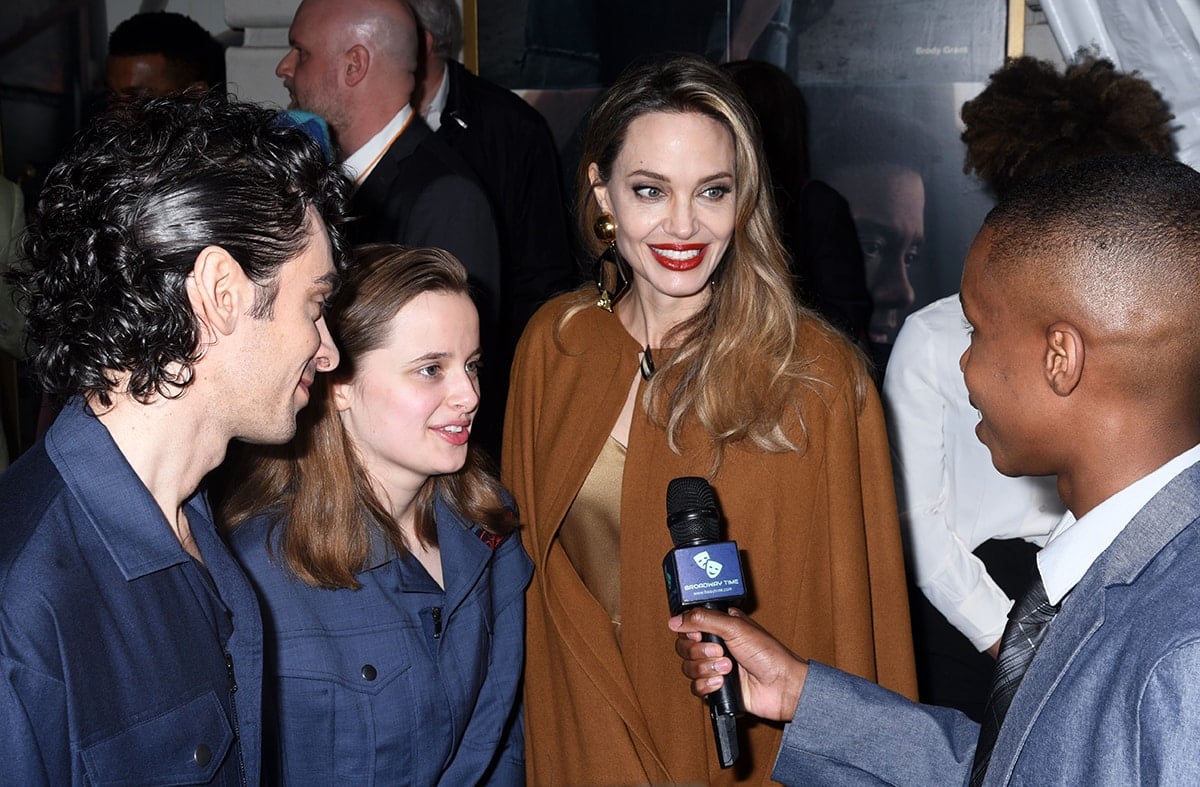 Justin Levine, Vivienne Jolie-Pitt, and Angelina Jolie at The Outsiders Broadway musical opening night at The Bernard B. Jacobs Theatre on April 11, 2024