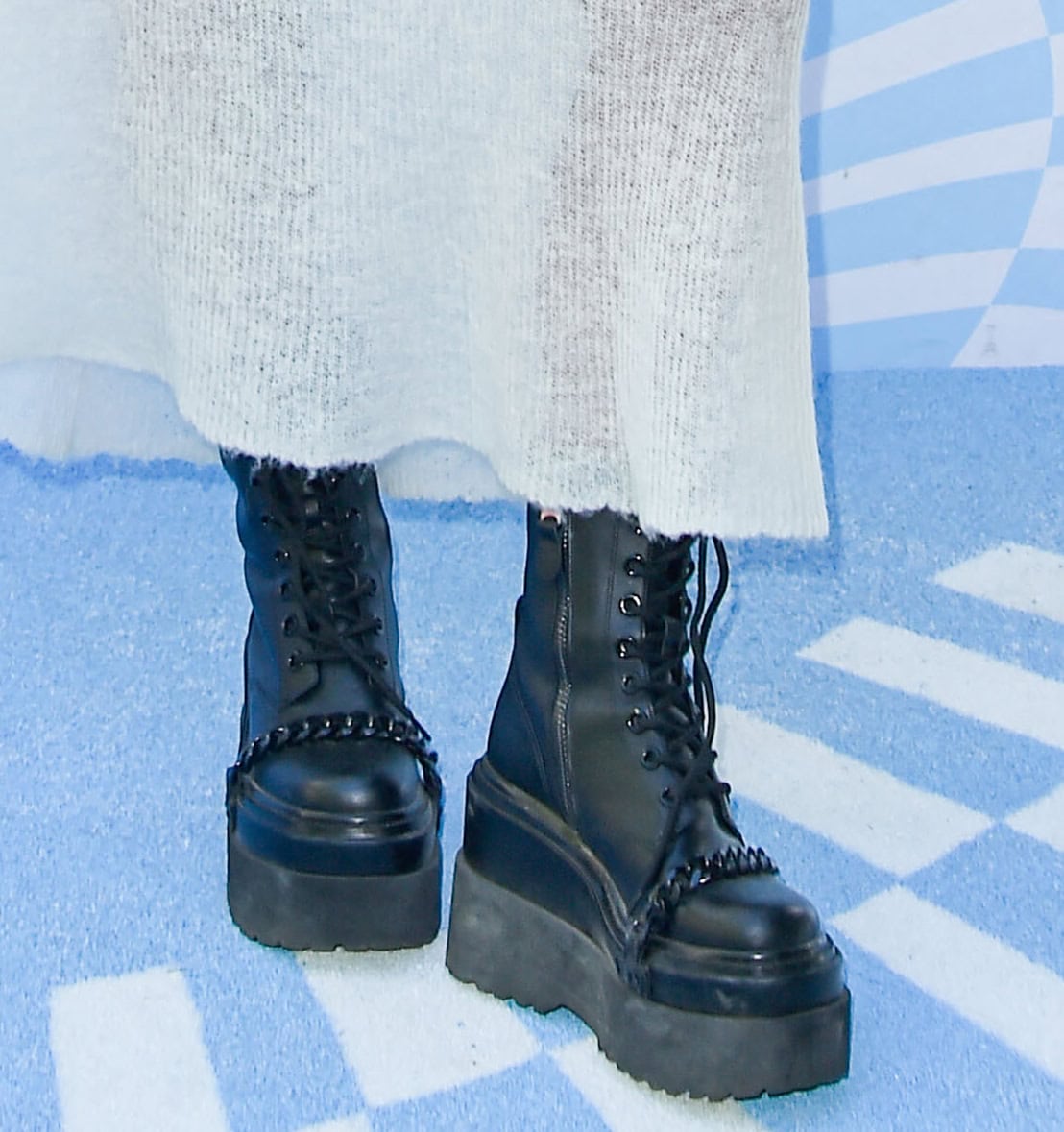 Charli D'Amelio toughens up her whimsical dress with the Camdon combat boots from her family's footwear brand, D'Amelio