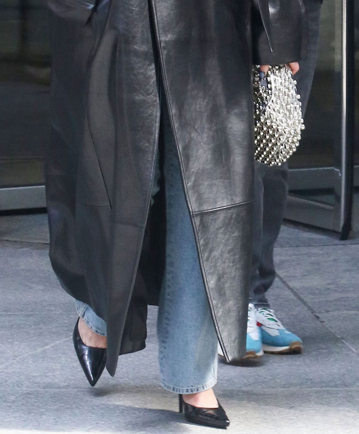 Dua Lipa elevates her casual 'fit with black croc pumps and a silver studded purse