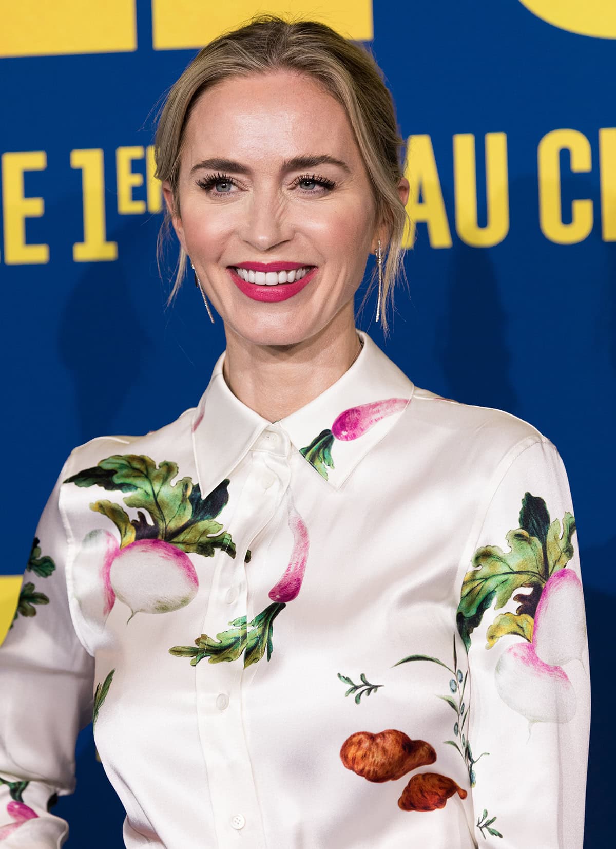 Emily Blunt teams her playful outfit with elegant Tiffany & Co. dangling earrings and Taylor Swift's friendship bracelets