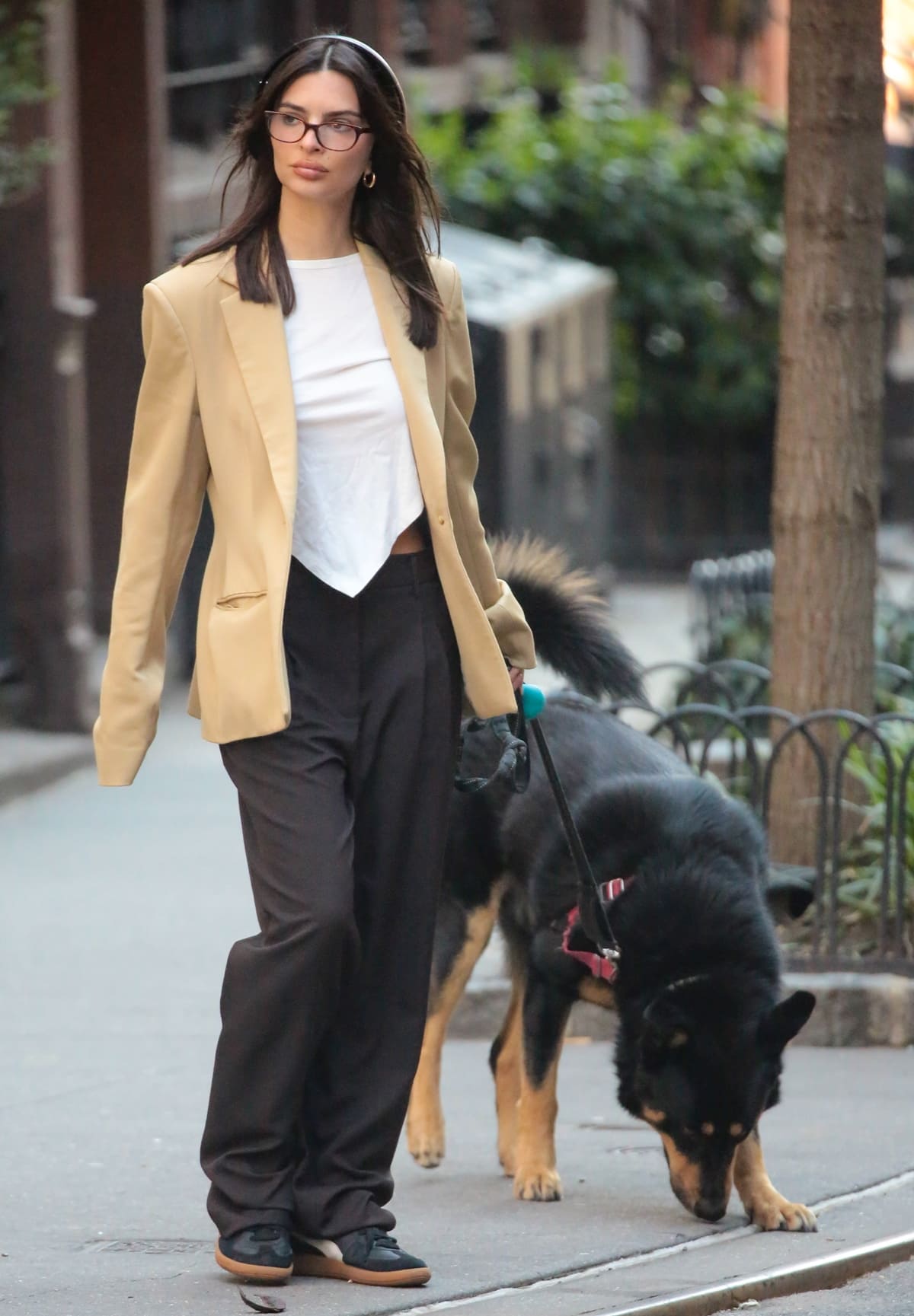 Accompanied by her loyal companion, Colombo, Emily Ratajkowski takes to the streets of West Village in style, her oversized beige blazer and Puma sneakers making a statement of effortless elegance and companionship