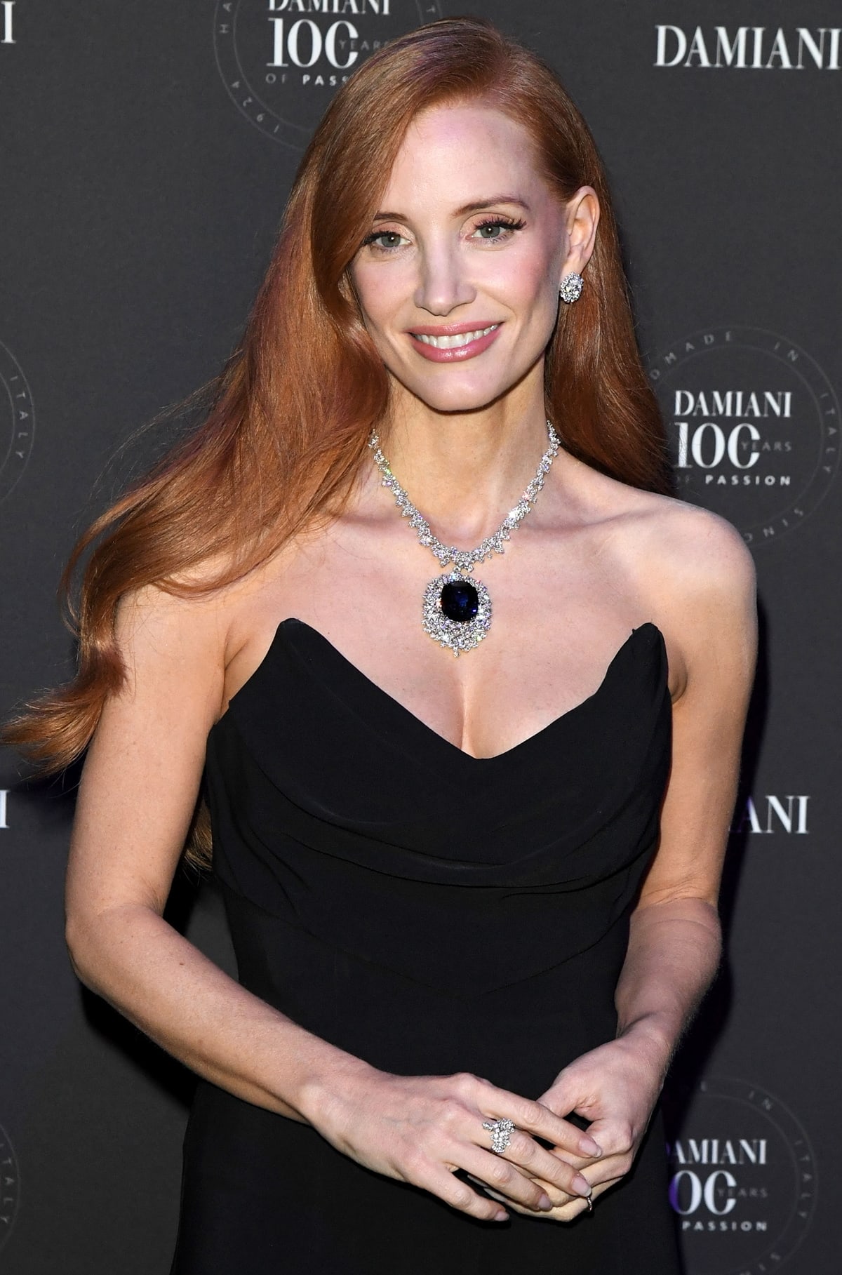 Jessica Chastain graces the Damiani 100th anniversary gala in Milan, her elegance magnified by the breathtaking Damiani sapphire diamond necklace, symbolizing a century of exquisite craftsmanship and luxury