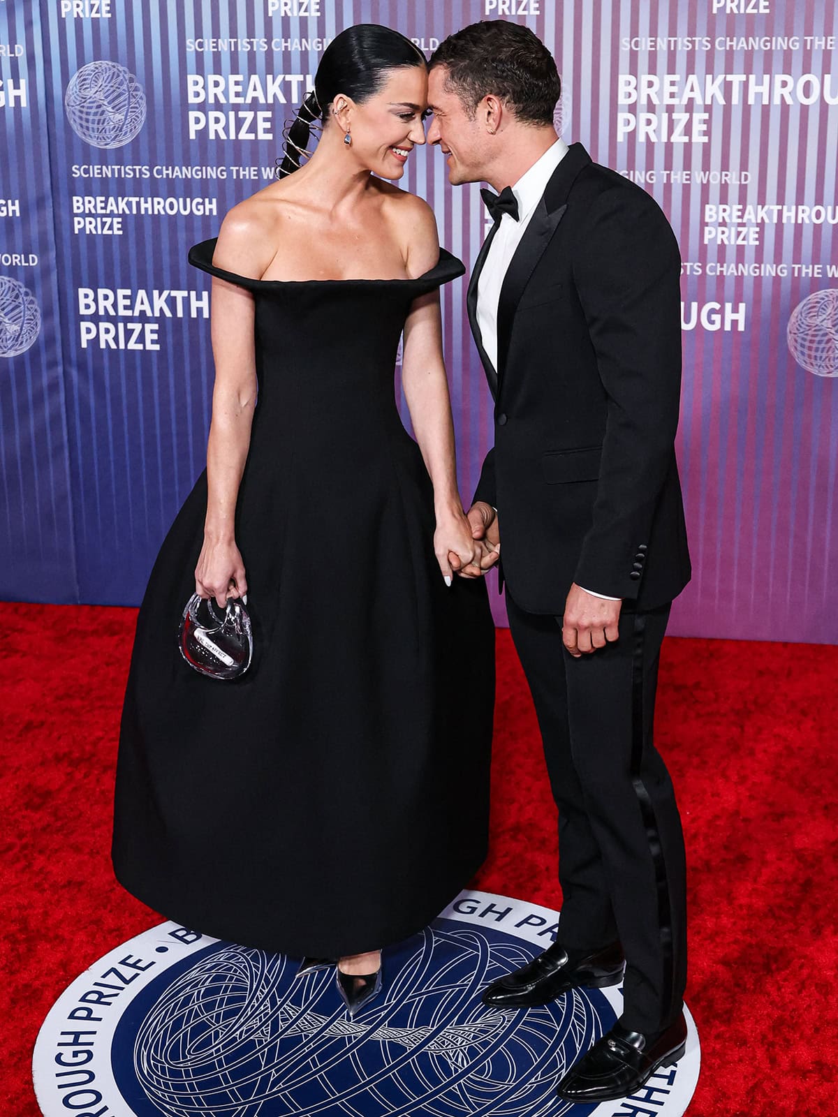 Katy Perry and Orlando Bloom exchanging gazes and rubbing noses in matching black ensembles at the 10th Annual Breakthrough Prize Ceremony held at the Academy Museum of Motion Pictures on April 13, 2024