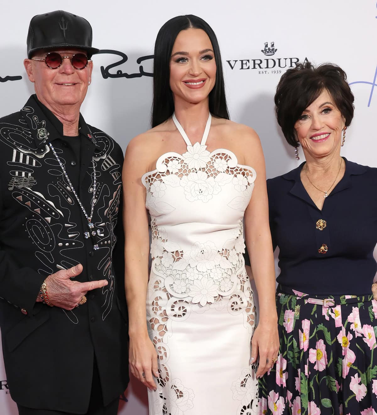 United in Love: Despite differing views, Katy Perry radiates affection with her parents at a Beverly Hills event, embodying the family's bond and mutual admiration