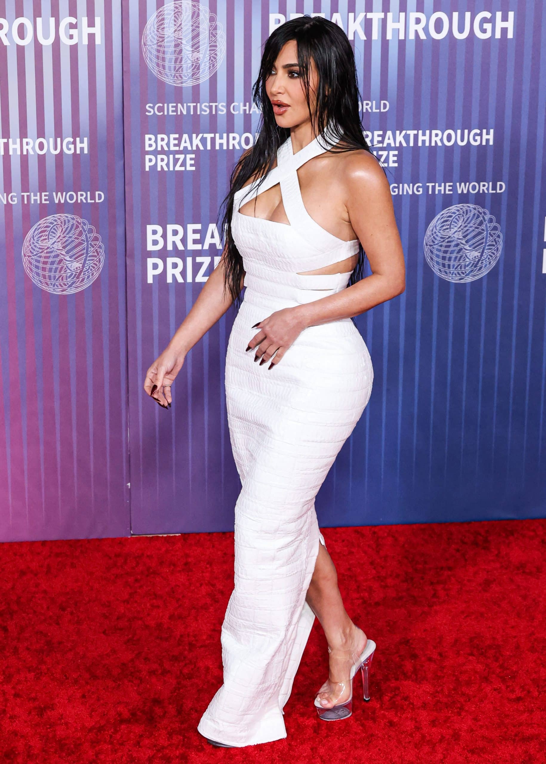 Kim Kardashian's white croc leather dress features a halterneck, a boob window, and sexy side slits and cutouts