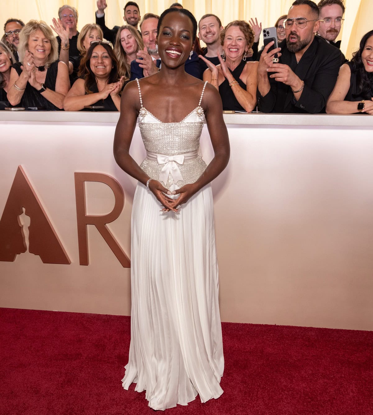 Lupita Nyong’o brings timeless elegance to the 2025 Oscars in a custom Chanel gown adorned with over 22,000 pearls, paired with exquisite Chanel fine jewelry