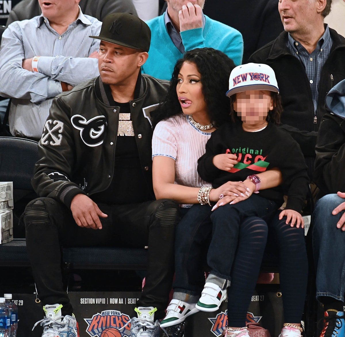 Nicki Minaj's husband Kenneth Petty looks cool in a black varsity jacket, ripped jeans, and Balenciaga sneakers, while their son Papa Bear dons a Gucci sweater with Gucci sneakers