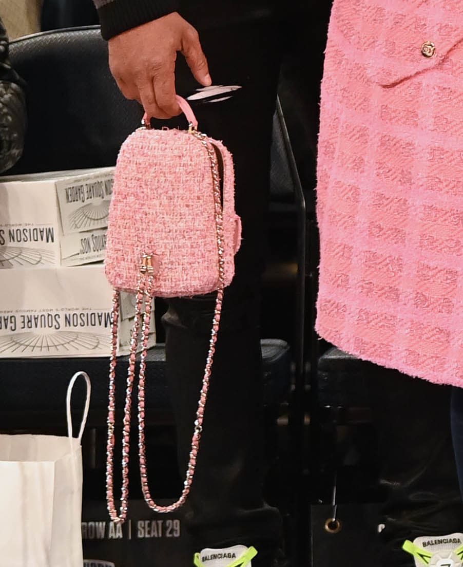 Nicki Minaj carries her things in a pink tweed mini phone holder backpack by Chanel