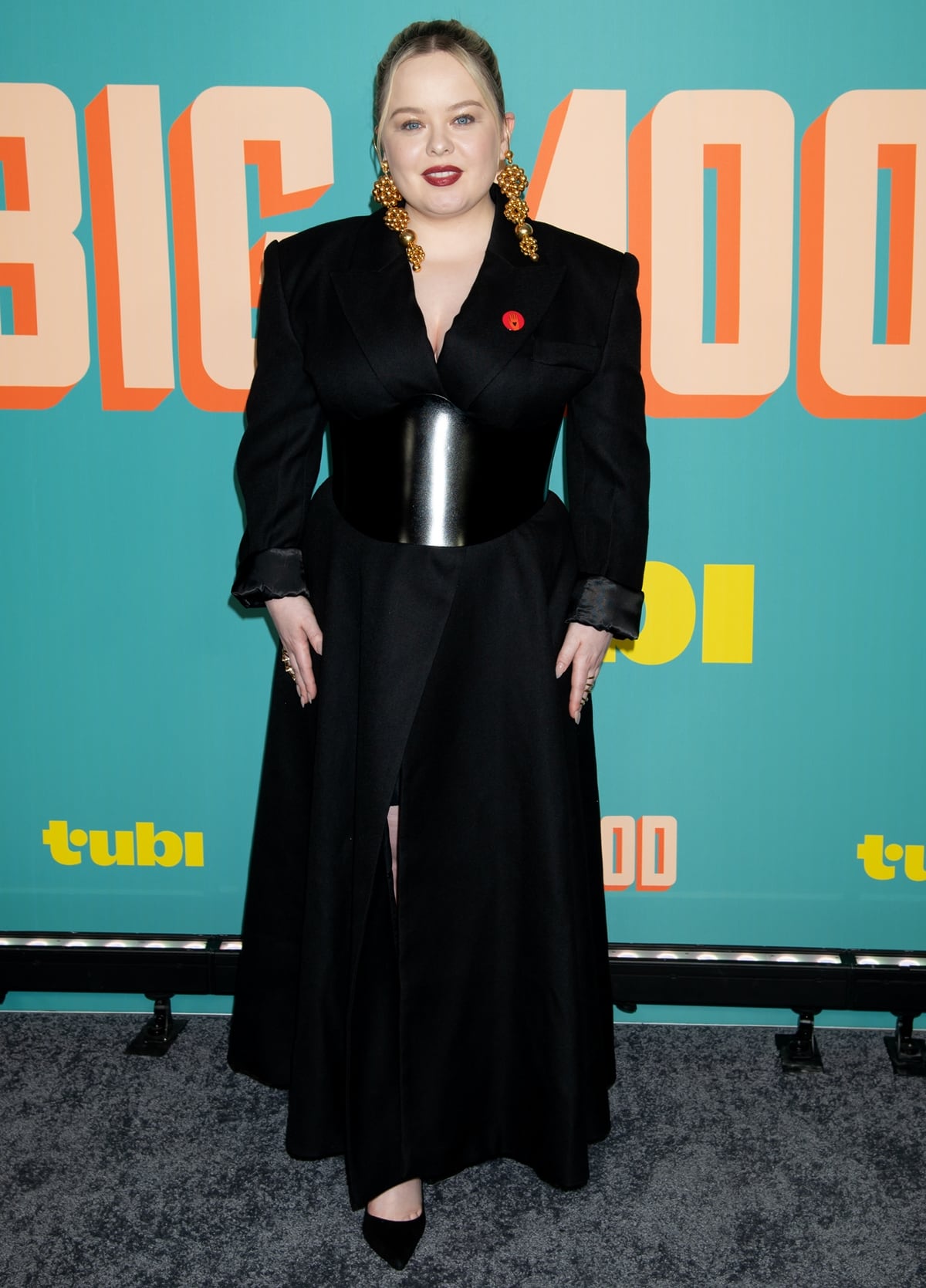 Nicola Coughlan strikes a balance between edgy and elegant in a belted black coat with bold shoulder pads at the Big Mood premiere in NYC