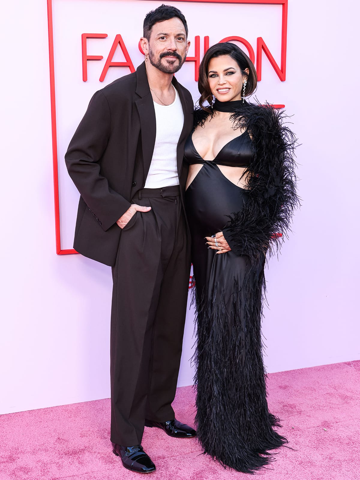 Jenna Dewan is joined on the pink carpet by her fiancé Steve Kazee clad in a dark brown suit with a white tank top and black oxford shoes