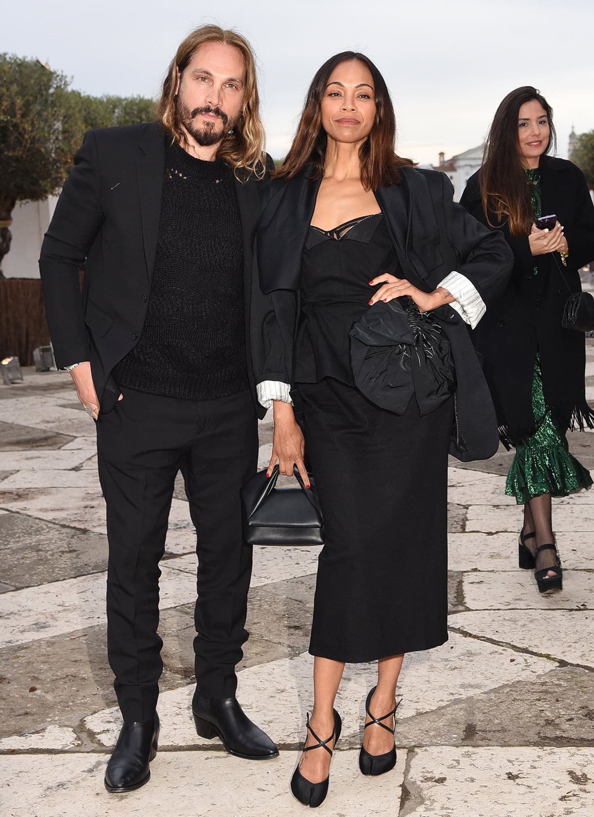 Marco Perego and Zoe Saldana are chic in matching black outfits at the gala dinner hosted by Francois Pinault celebrating the 60th Biennale Art 2024 in Venice, Italy on April 17, 2024