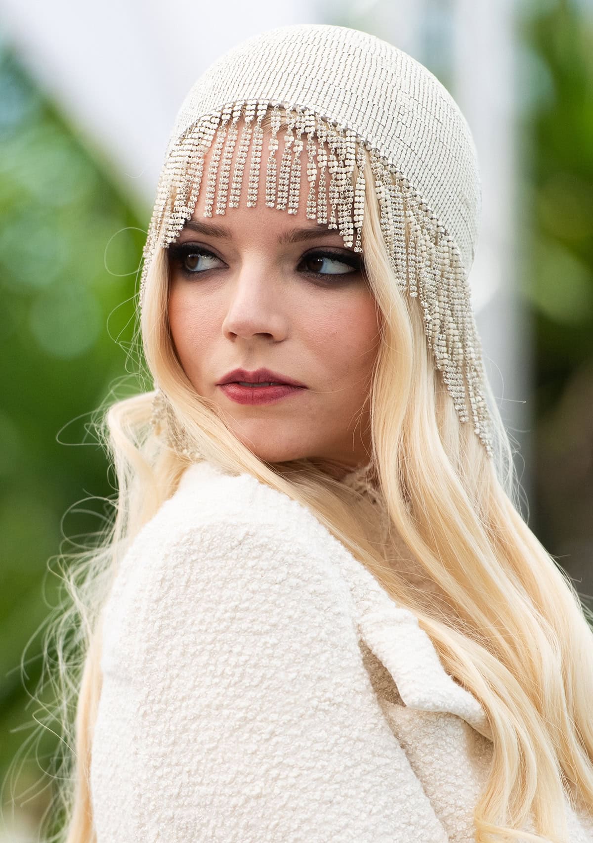 Anya Taylor-Joy embraces the 1920s with her flapper-inspired chainmail headdress with beaded fringes