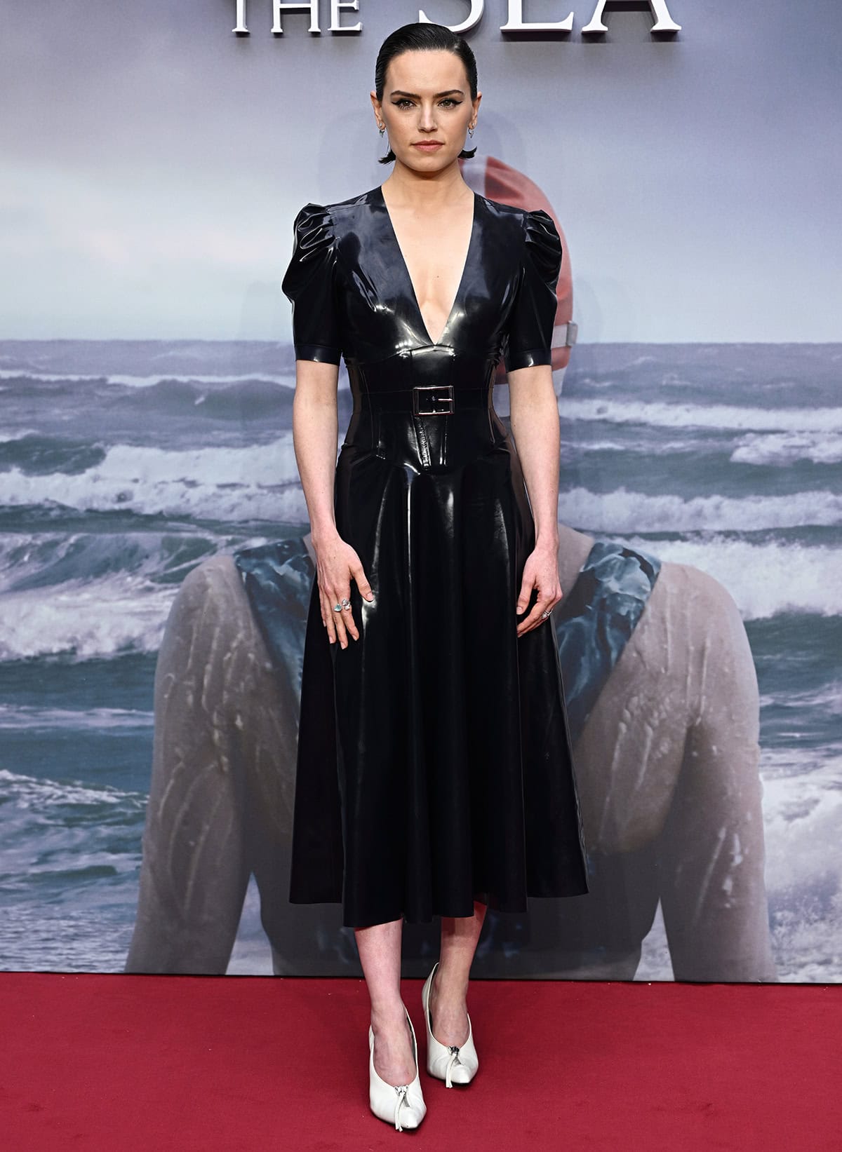 Daisy Ridley looks sleek in a navy-blue latex dress by Japanese designer Atsuko Kudo
