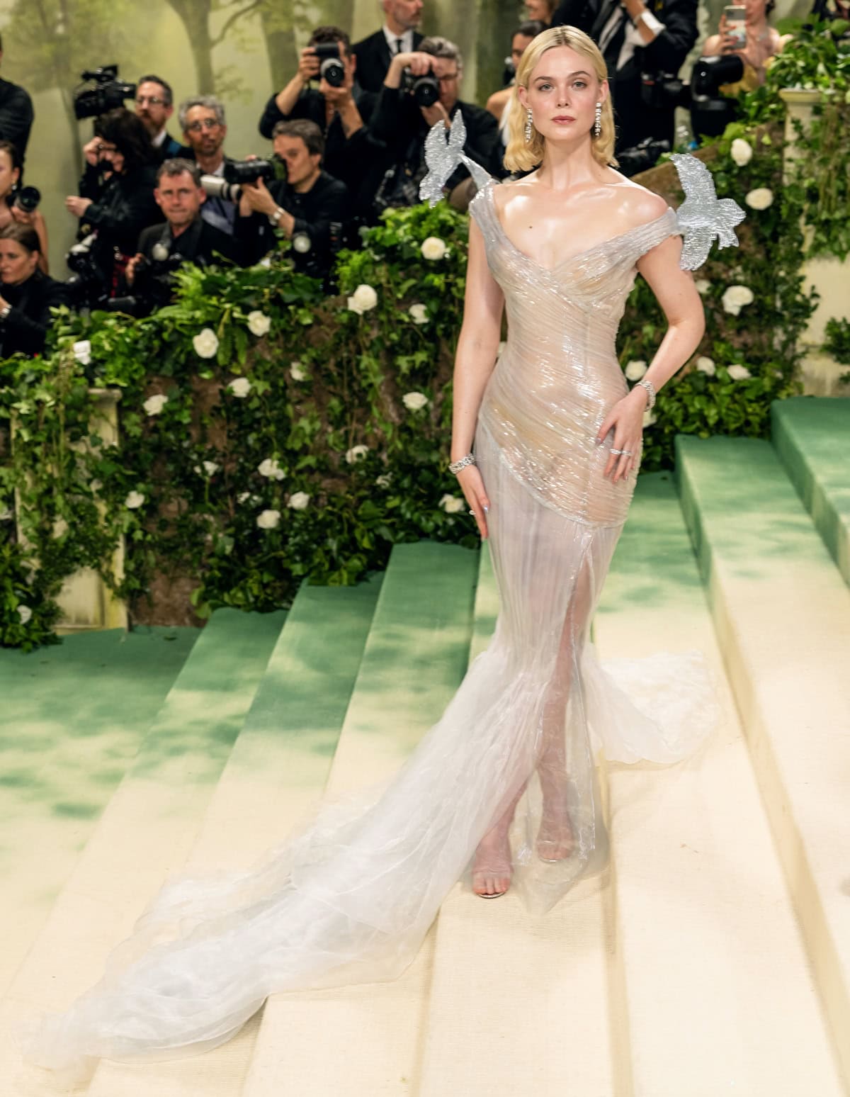 The intricate detailing of Elle Fanning's gown, inspired by J.G. Ballard’s 'The Garden of Time', features shimmering tulle and crystal 'birds' that add a whimsical, ethereal touch to her ensemble