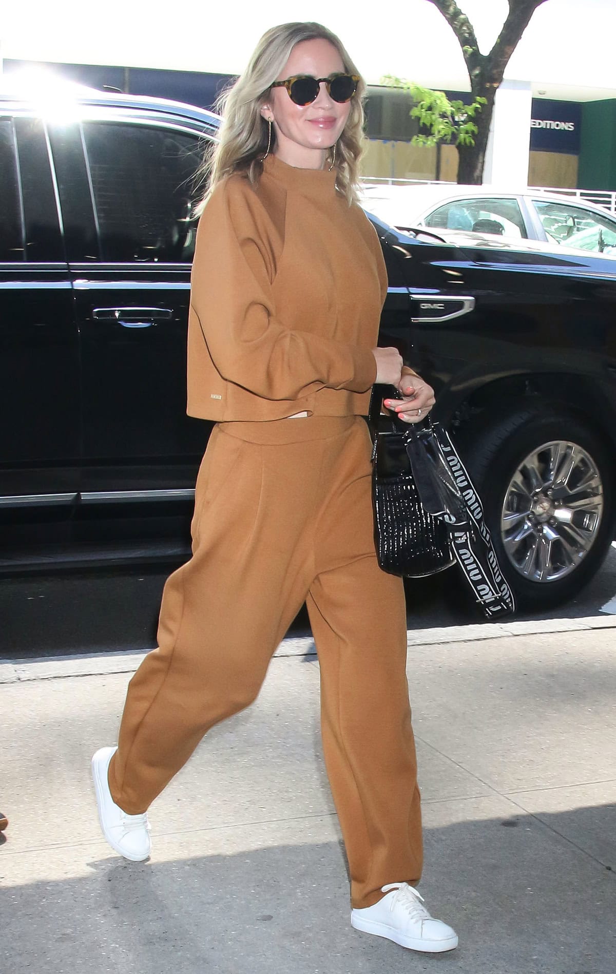 Emily Blunt promotes The Fall Guy in a brown co-ord athleisure and white sneakers at The Drew Barrymore Show on May 2, 2024