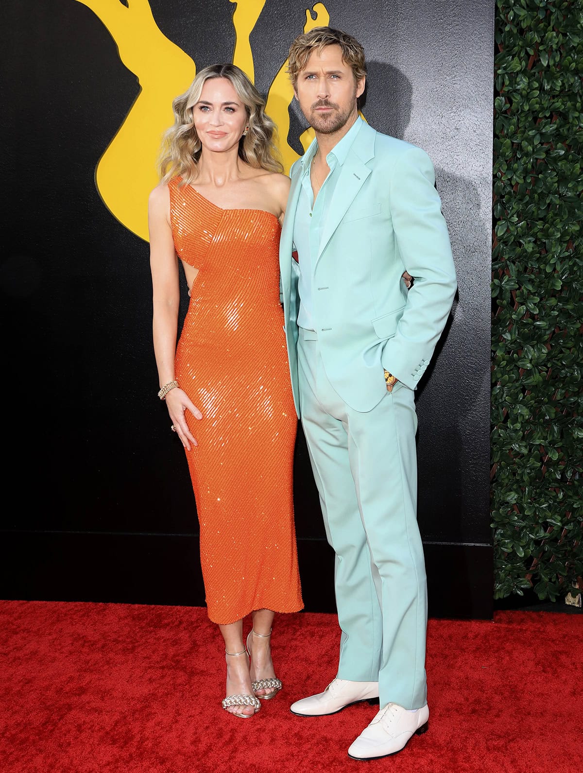 Emily Blunt and Ryan Gosling in complementary orange and mint green outfits at the Los Angeles premiere of their movie, The Fall Guy, at the Dolby Theatre on April 30, 2024