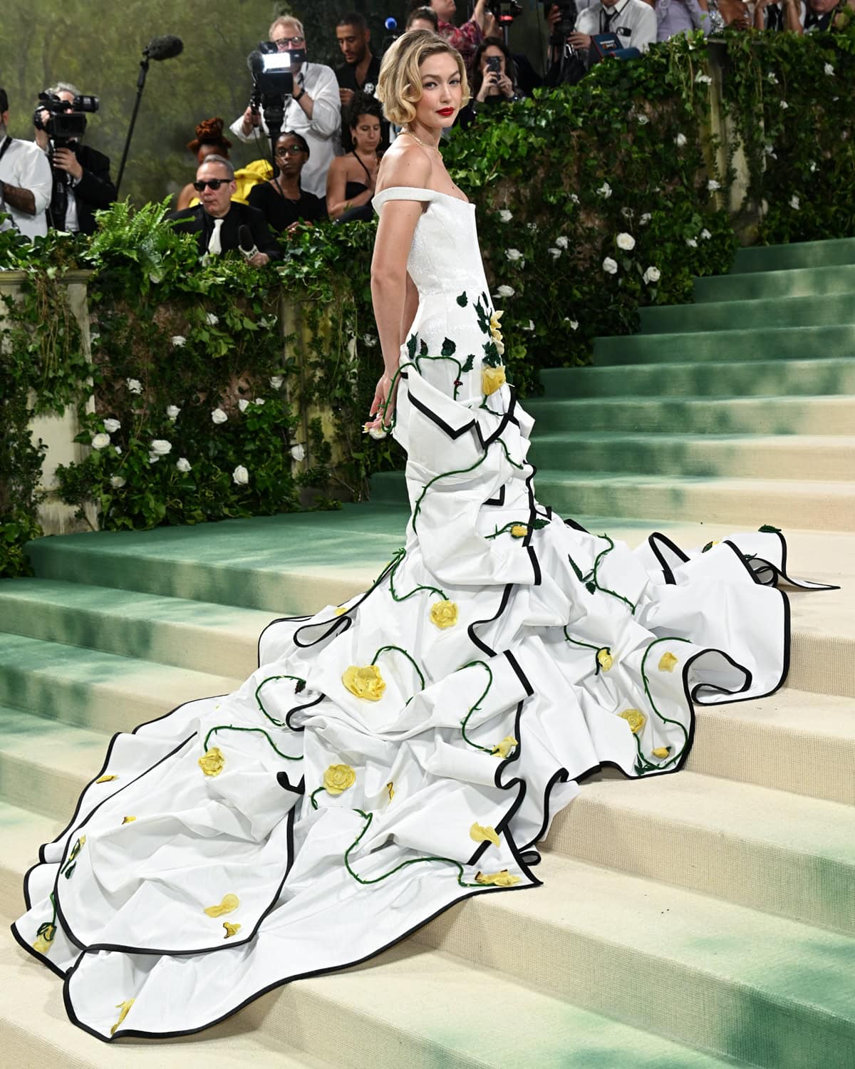 A floral fantasy: Gigi Hadid enchants in a Thom Browne gown with hand-embroidered details at the 2024 Met Gala, embodying the night's 'Garden of Time' theme