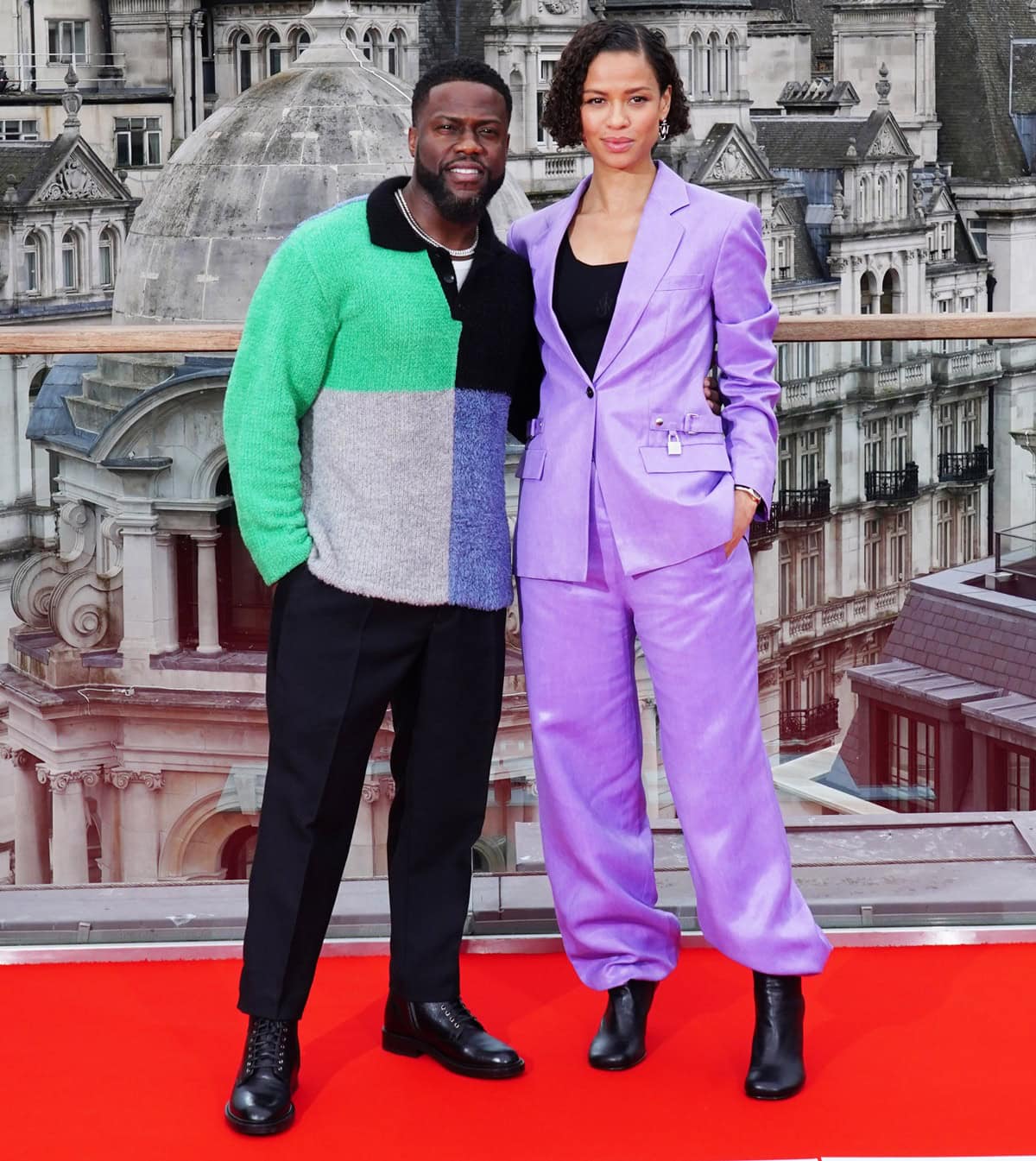 Gugu Mbatha-Raw, who stands 5ft 4in, wore a bold J.W. Anderson purple padlock suit with wide-leg trousers and black boots, while Kevin Hart, in black boots and a color-block sweater by The Elder Statesman, added casual polish to the red carpet moment