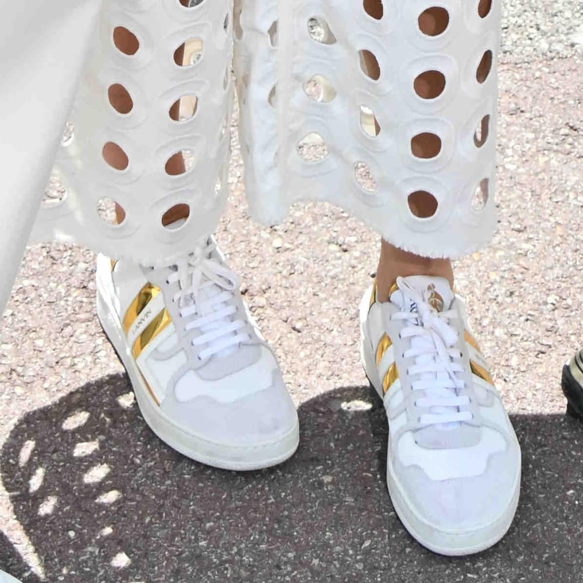 Heidi Klum completes her chic look with a pair of stylish white Lanvin sneakers featuring gold detailing at the F1 Grand Prix of Monaco